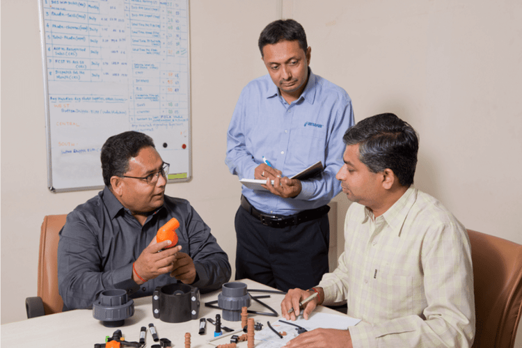 Men walking in farm field